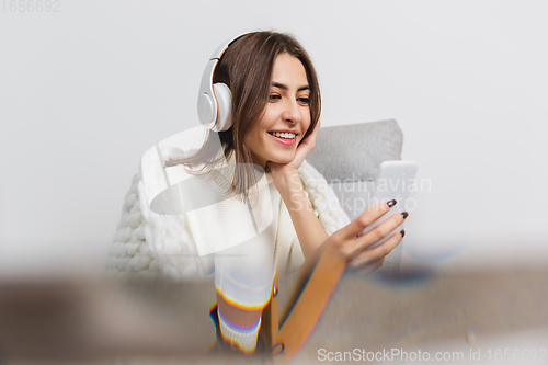 Image of Portrait of beautiful woman isolated on white studio background. Comfort, warm in winter concept