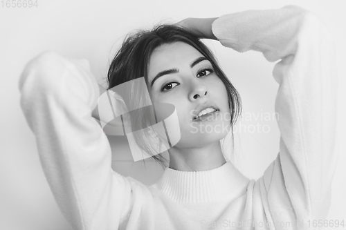 Image of Portrait of beautiful woman isolated on white studio background. Comfort, warm in winter concept