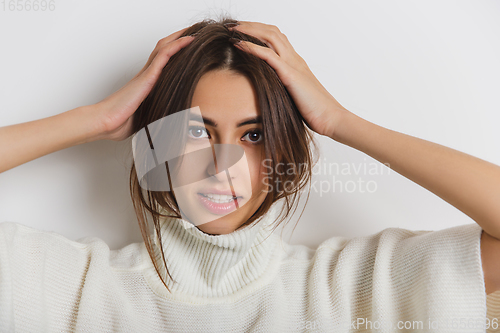 Image of Portrait of beautiful woman isolated on white studio background. Comfort, warm in winter concept