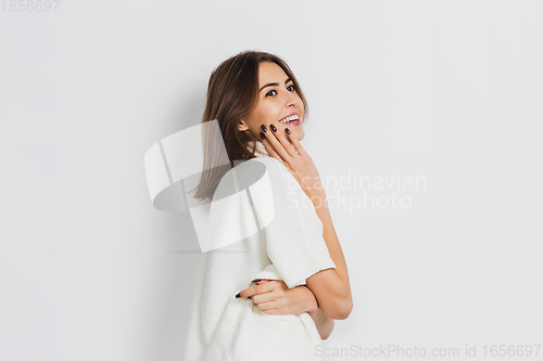 Image of Portrait of beautiful woman isolated on white studio background. Comfort, warm in winter concept