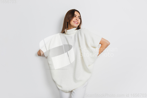 Image of Portrait of beautiful woman isolated on white studio background. Comfort, warm in winter concept