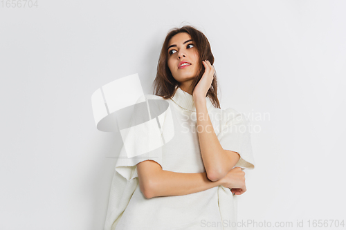 Image of Portrait of beautiful woman isolated on white studio background. Comfort, warm in winter concept