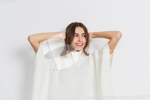 Image of Portrait of beautiful woman isolated on white studio background. Comfort, warm in winter concept