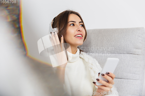 Image of Portrait of beautiful woman isolated on white studio background. Comfort, warm in winter concept