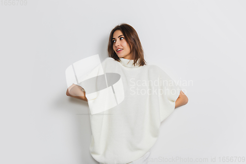 Image of Portrait of beautiful woman isolated on white studio background. Comfort, warm in winter concept