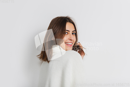 Image of Portrait of beautiful woman isolated on white studio background. Comfort, warm in winter concept