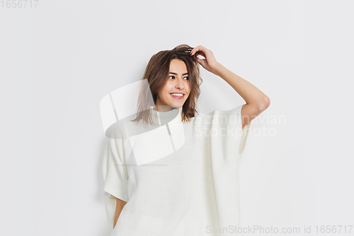 Image of Portrait of beautiful woman isolated on white studio background. Comfort, warm in winter concept