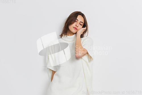 Image of Portrait of beautiful woman isolated on white studio background. Comfort, warm in winter concept