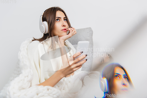 Image of Portrait of beautiful woman isolated on white studio background. Comfort, warm in winter concept