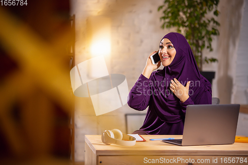 Image of Happy muslim woman at home during online lesson. Modern technologies, remote education, ethnicity concept
