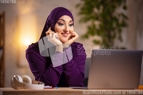 Image of Happy muslim woman at home during online lesson. Modern technologies, remote education, ethnicity concept