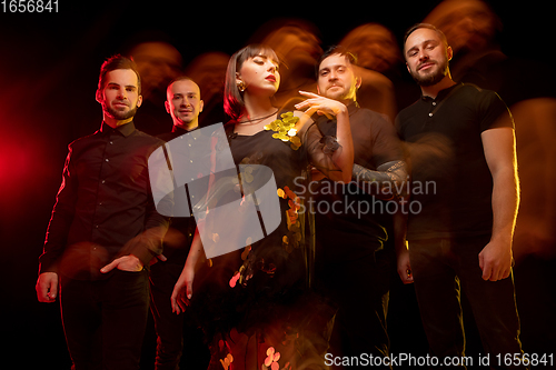 Image of Musician\'s band isolated on dark studio background in neon light