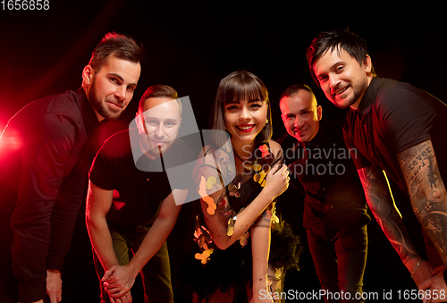 Image of Musician\'s band isolated on dark studio background in neon light