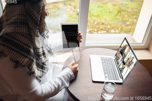 Image of Arabian businessman working in office, business centre using devicesm gadgets. Lifestyle