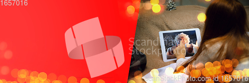 Image of Happy caucasian little girl during video call or messaging with Santa using laptop and home devices, celebration or ad flyer with copyspace