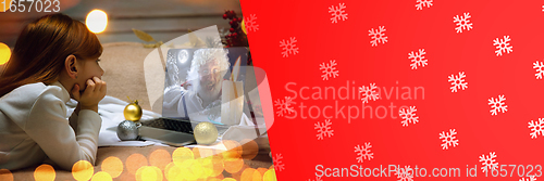 Image of Happy caucasian little girl during video call or messaging with Santa using laptop and home devices, celebration or ad flyer with copyspace