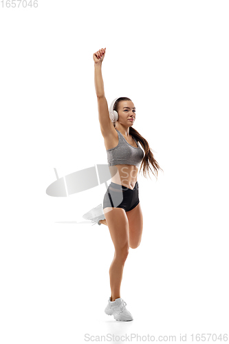 Image of Caucasian professional female runner, athlete training isolated on white studio background. Copyspace for ad.