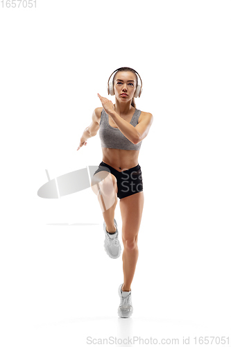 Image of Caucasian professional female runner, athlete training isolated on white studio background. Copyspace for ad.