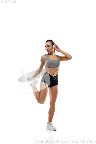 Image of Caucasian professional female runner, athlete training isolated on white studio background. Copyspace for ad.