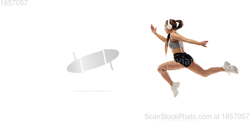 Image of Caucasian professional female runner, athlete training isolated on white studio background. Copyspace for ad.