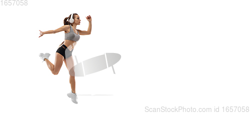 Image of Caucasian professional female runner, athlete training isolated on white studio background. Copyspace for ad.