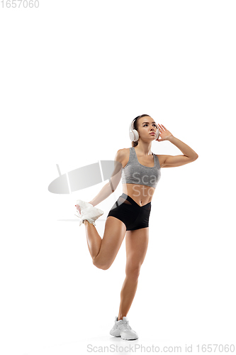 Image of Caucasian professional female runner, athlete training isolated on white studio background. Copyspace for ad.