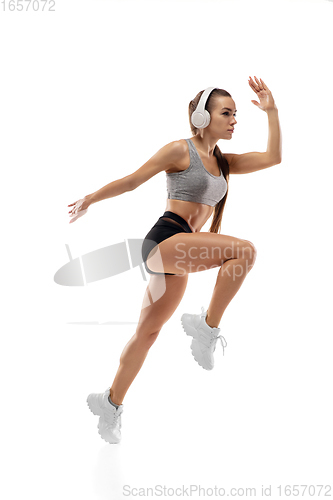 Image of Caucasian professional female runner, athlete training isolated on white studio background. Copyspace for ad.