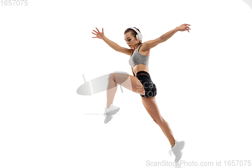 Image of Caucasian professional female runner, athlete training isolated on white studio background. Copyspace for ad.