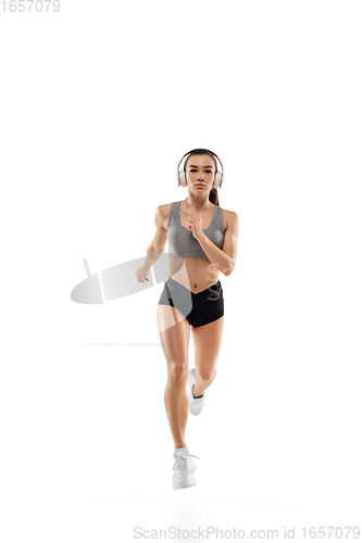 Image of Caucasian professional female runner, athlete training isolated on white studio background. Copyspace for ad.