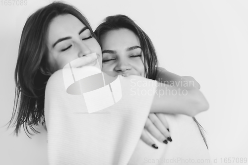 Image of Portrait of beautiful women isolated on white studio background. Comfort, warm in winter concept
