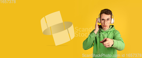 Image of Portrait of young caucasian man isolated on yellow studio background