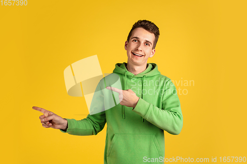 Image of Portrait of young caucasian man isolated on yellow studio background