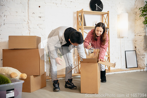 Image of New property owners, young couple moving to new home, apartment, look happy