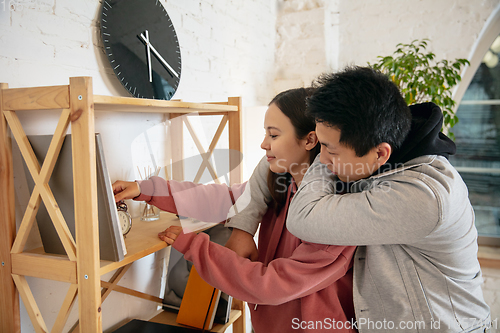 Image of New property owners, young couple moving to new home, apartment, look happy