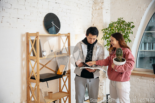 Image of New property owners, young couple moving to new home, apartment, look happy