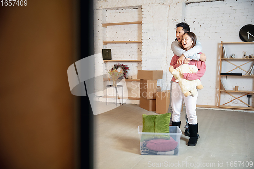 Image of New property owners, young couple moving to new home, apartment, look happy