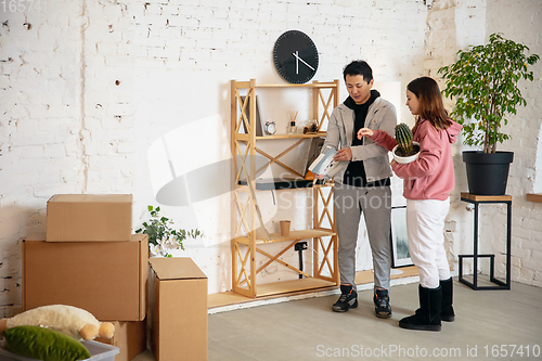 Image of New property owners, young couple moving to new home, apartment, look happy