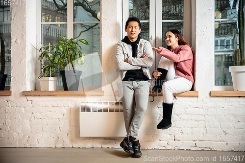 Image of New property owners, young couple moving to new home, apartment, look happy