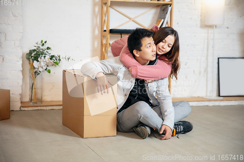 Image of New property owners, young couple moving to new home, apartment, look happy