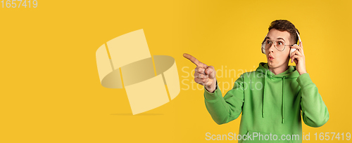 Image of Portrait of young caucasian man isolated on yellow studio background