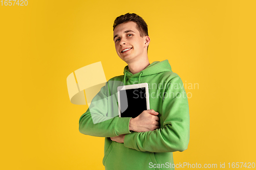 Image of Portrait of young caucasian man isolated on yellow studio background