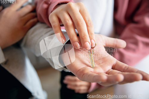 Image of New property owners, young couple moving to new home, apartment, close up