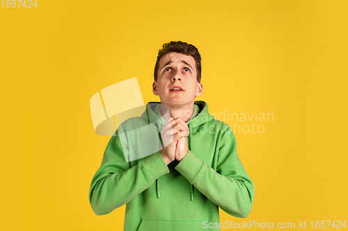 Image of Portrait of young caucasian man isolated on yellow studio background