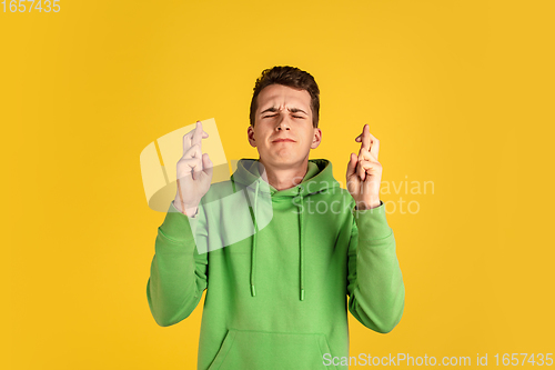 Image of Portrait of young caucasian man isolated on yellow studio background