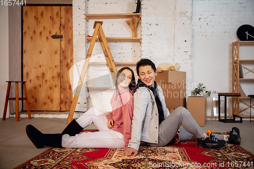 Image of New property owners, young couple moving to new home, apartment, look happy