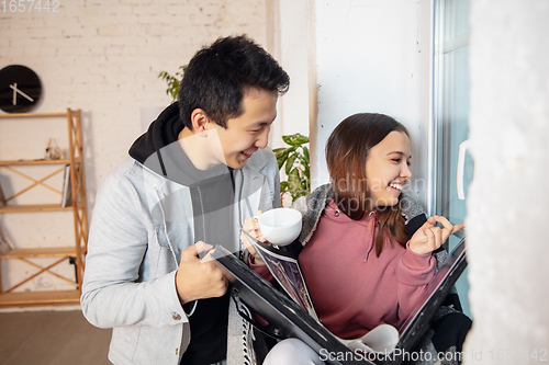 Image of New property owners, young couple moving to new home, apartment, look happy