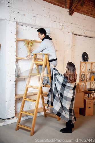 Image of New property owners, young couple moving to new home, apartment, look happy