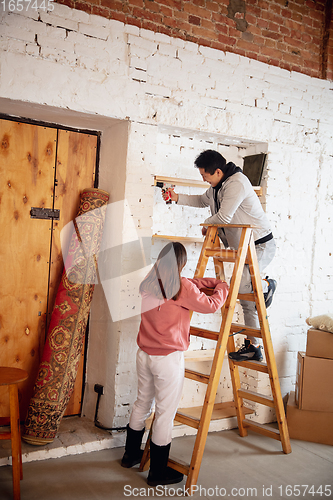 Image of New property owners, young couple moving to new home, apartment, look happy