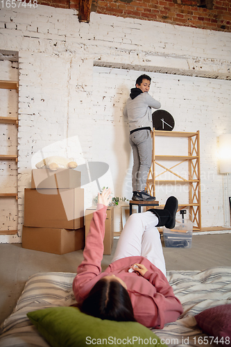 Image of New property owners, young couple moving to new home, apartment, look happy