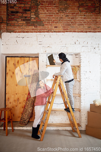 Image of New property owners, young couple moving to new home, apartment, look happy